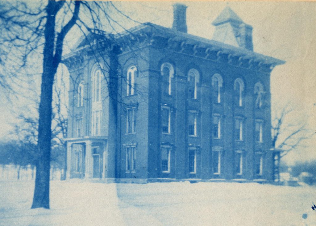 A cyanotype image of the 3 story, brick building known as Preparatory Hall.