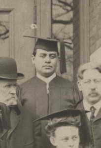 Charles Lewis Williams stands in his black graduation cap and gown on the steps of Bowen Hall.