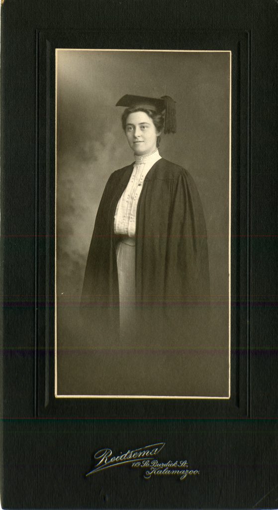 Black and white photo of Stella Fisher Burgess '05 in her black graduation cap and gown.